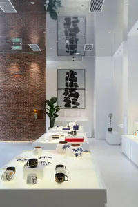 Modern retail shop display with white brick walls and concrete accents, showcasing innovative design elements.