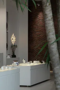 Modern retail storefront displaying ceramic ware on shelves.