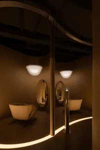 A modern spa setting featuring round lighting fixtures and neutral-toned furnishings.