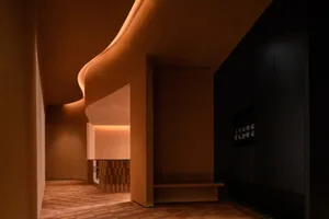 A contemporary spa interior with modern concrete elements and curved lighting.