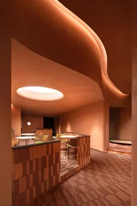 A modern cafe interior featuring exposed brick walls and warm, ambient lighting.