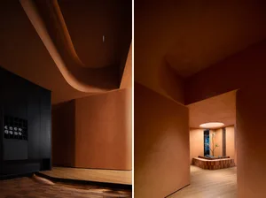 A modern spa interior with clay walls and wooden floors.