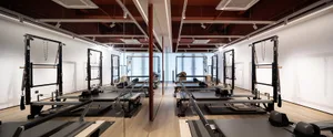 Modern fitness center with metal reformer equipment.