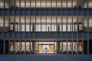 一座現代圖書館建築，擁有混凝土外牆與大型玻璃窗。