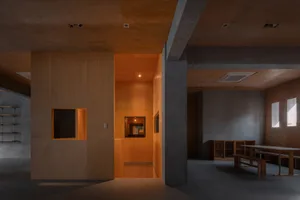 Interior design of a modern office space featuring wooden and concrete elements.