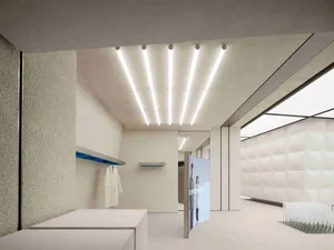 Modern minimalist retail store with concrete walls and white surfaces. White retail store with concrete accents and glass ele
