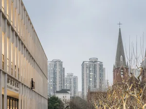 A modern cityscape featuring concrete and glass buildings.