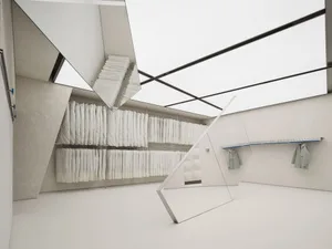 Inside a modern clothing store with glass walls and ceiling, featuring dressing racks and shelves.