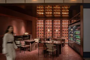 Modern interior design of a restaurant-bar with metallic and glass elements.