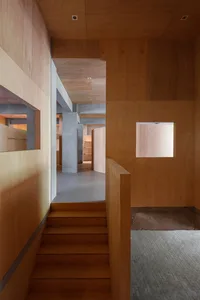 A modern interior space featuring wooden walls and stairs.