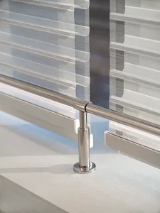 Modern minimalist design featuring metal railings on a concrete floor.