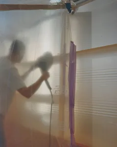 Person sanding plastic wrap in a construction setting