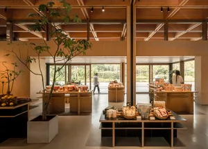 Retail store featuring minimalist design with wood, concrete, and glass elements.