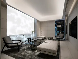 A modern minimalist living room featuring neutral-toned materials and a serene atmosphere.