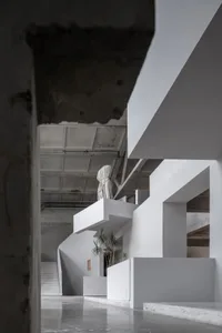 A white concrete staircase with modern design features in an interior space.