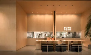 Industrial design restaurant interior with wooden walls and tables.