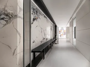 Modern furniture and marble glass walls in a corridor interior design