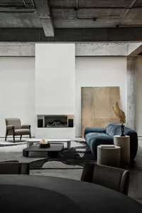 Modern living room featuring industrial design elements and concrete materials.