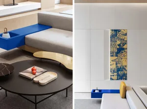 A modern living room featuring a blue accent tile floor accompanied by a minimalist sofa and a round coffee table with a book