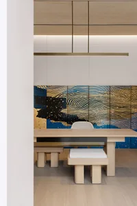 A modern dining room with wooden furniture and abstract art.