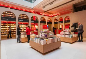 Modern bookstore with wooden shelves and a variety of books on display