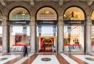 A modern bookstore with glass storefront windows, featuring the Mondadori logo.