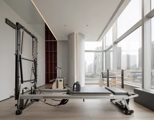 A spacious modern fitness center with glass walls。