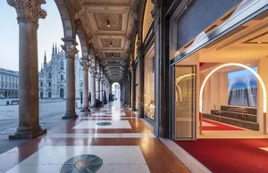 A modern retail space featuring marble countertops, glass display cases, and concrete flooring.
