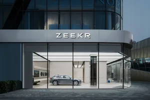 Automotive showroom exterior with glass facade and a ZEKR logo.