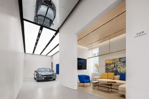Modern showroom featuring blue accent furniture and floating carpets