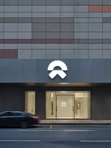 Modern storefront with a glass entrance, concrete facade, and metal elements.