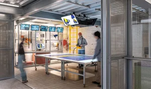 A showroom with an array of cameras and digital screens, showcasing technological equipment.