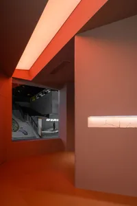 A minimalist interior space featuring concrete walls and floors.