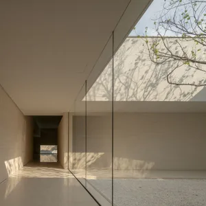 A modern living room with glass ceiling panels, showcasing a minimalist design.