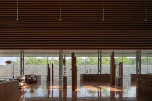A modern lobby features wooden elements and a spacious, open design.