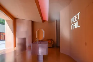 A modern nail salon with sleek, minimalist design and concrete finishes.