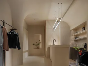 A modern closet space with a mix of neutral materials and soft lighting.
