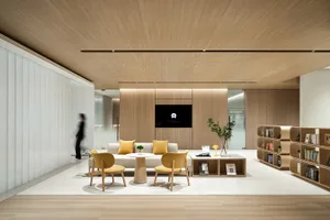 A modern office reception area featuring wood materials and minimalist design.