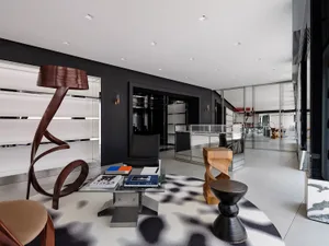 A modern office space featuring metal, glass, and wood elements.