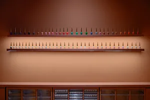 Modern retail display shelves with multiple bottles of nail polish arranged neatly on floating shelves.