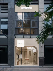 A modern retail storefront featuring glass windows and minimalist design.