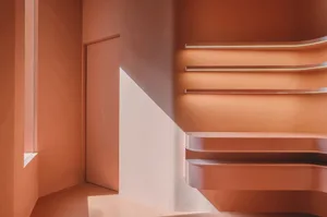 A modern staircase with metallic steps and handrails, featuring a sleek and contemporary design.