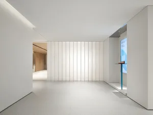 A minimalist office space featuring glass walls.