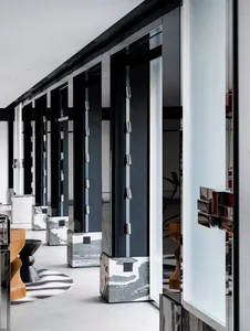 A modern, sleek entryway featuring black glass panels and metallic accents.