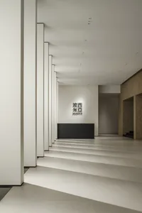 Modern minimalist lobby featuring concrete walls and flooring.