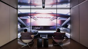 Two people sitting in a modern automotive interior design rendering, showcasing futuristic and minimalist aesthetics.