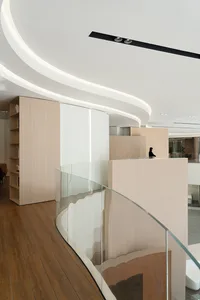 A modern interior office space featuring modular furniture and glass partitions.