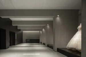A modern retail storefront with concrete walls and white flooring.