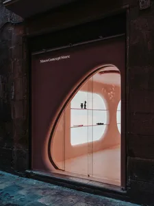 Modern storefront featuring glass and concrete materials in a retail setting.