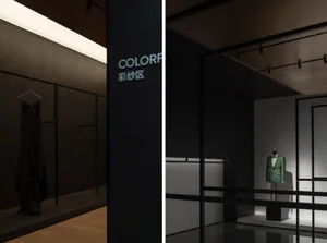 A black gown and a green jacket on mannequins in a store display.